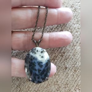 Sterling silver chain and stone pendant.